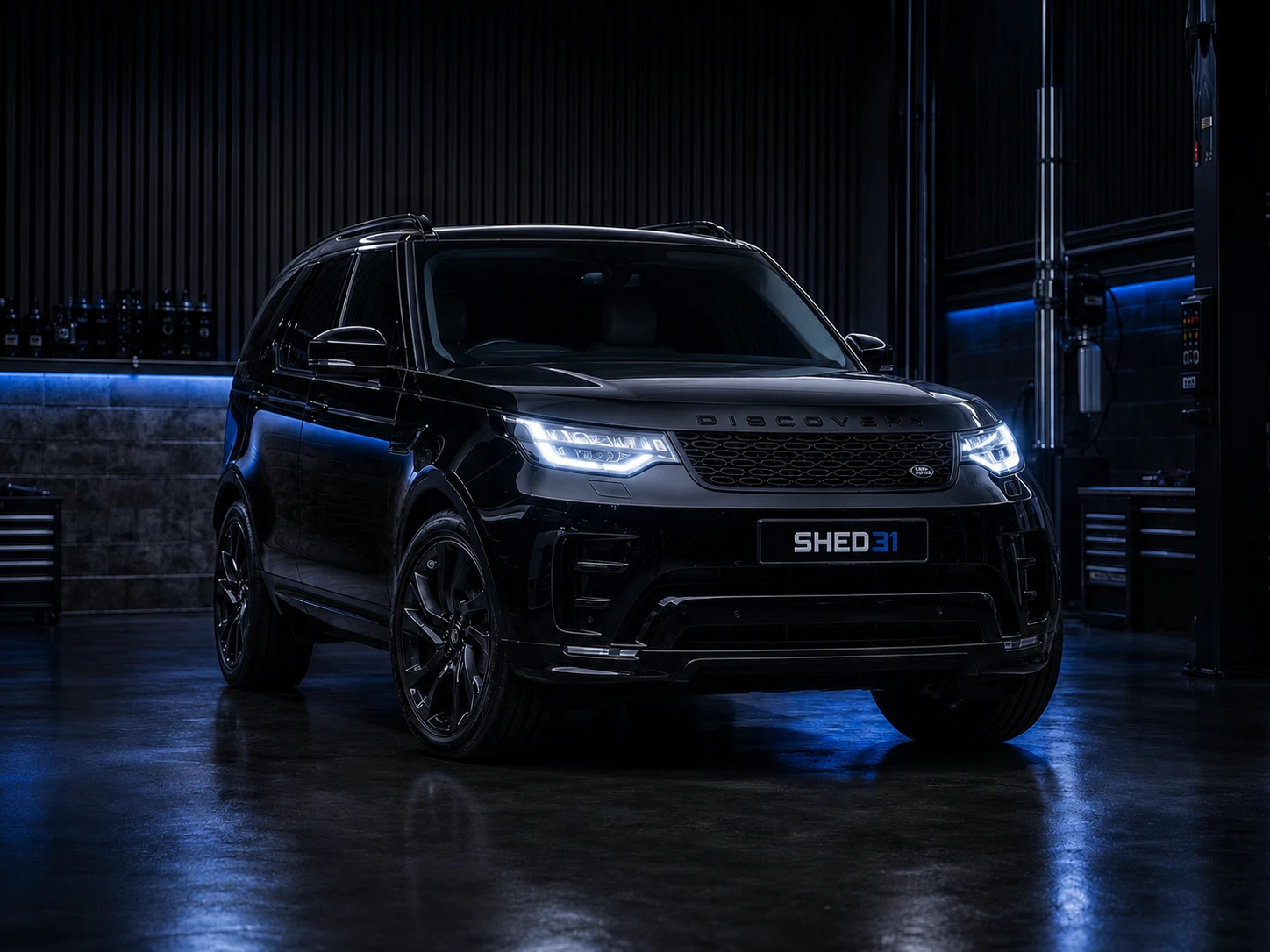 Black Land Rover Discovery in the Shed 31 workshop